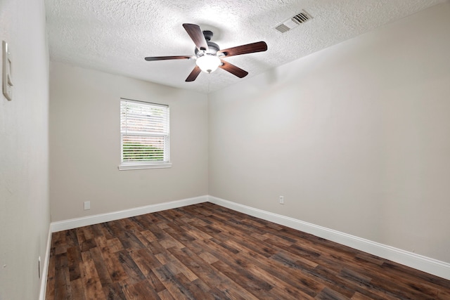 unfurnished room featuring ceiling fan, dark wood-type flooring, and a textured ceiling