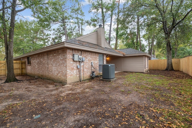 rear view of property featuring central AC unit