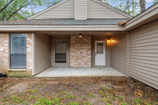 view of exterior entry with a patio area