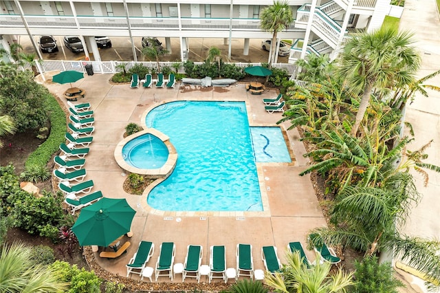 view of pool with a hot tub and a patio