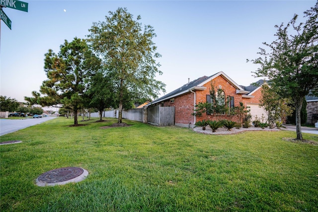 view of side of home with a yard