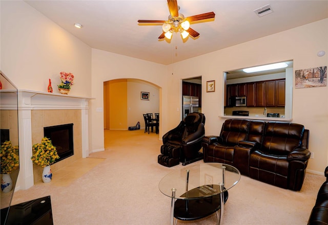 15830 Mesenbrink Ln, Houston, TX 77049 - living room with light carpet, a tile fireplace, and ceiling fan