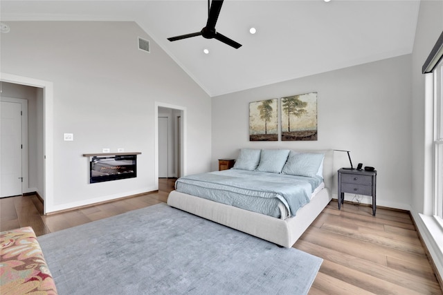 bedroom featuring light hardwood / wood-style flooring, high vaulted ceiling, and ceiling fan