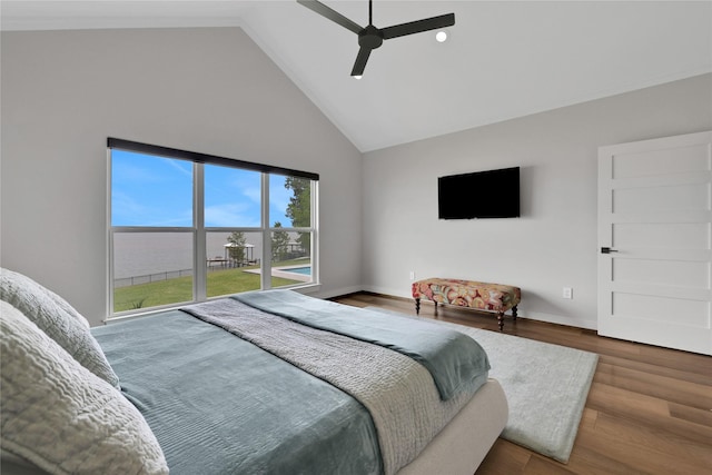 bedroom with hardwood / wood-style flooring, ceiling fan, and high vaulted ceiling