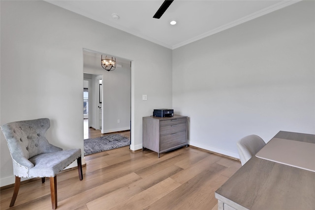 home office featuring ceiling fan with notable chandelier, ornamental molding, and light hardwood / wood-style floors