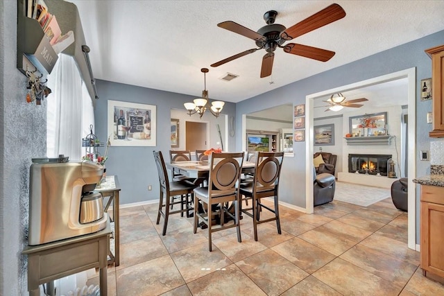 dining area featuring an inviting chandelier, plenty of natural light, and a textured ceiling