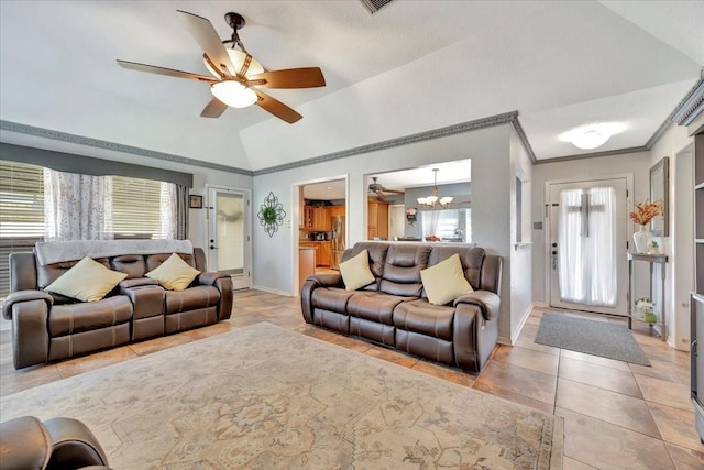 tiled living room featuring crown molding, lofted ceiling, and ceiling fan with notable chandelier