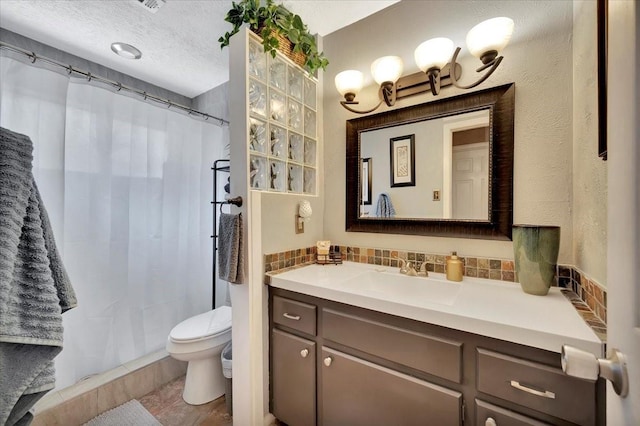 bathroom featuring tasteful backsplash, vanity, a textured ceiling, and toilet