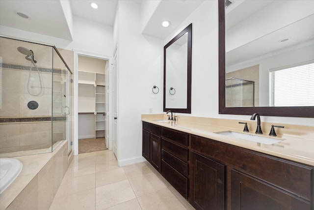 bathroom featuring vanity, shower with separate bathtub, and tile patterned floors