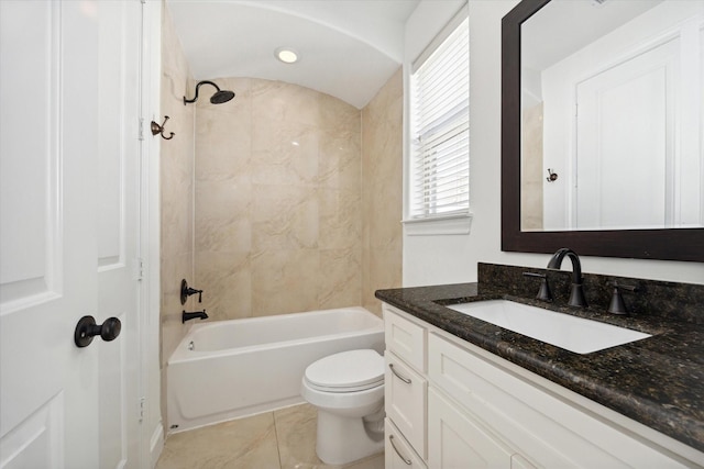 full bathroom featuring tiled shower / bath, vanity, toilet, and tile patterned floors