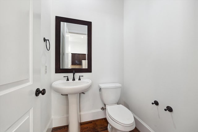 bathroom featuring sink, hardwood / wood-style floors, and toilet