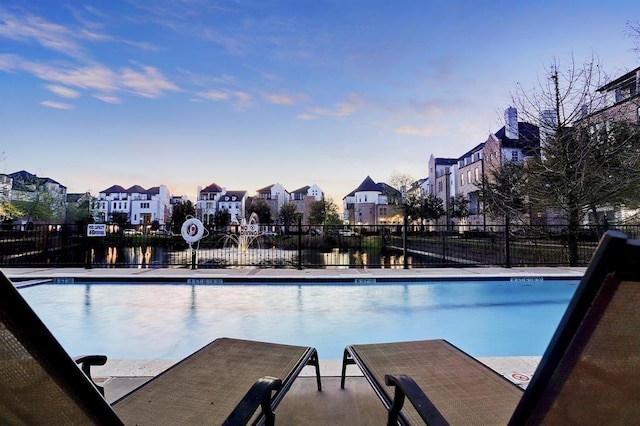 view of pool at dusk