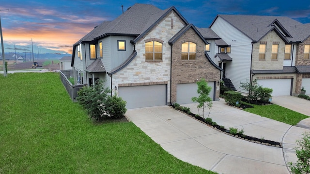 view of front facade featuring a garage and a yard