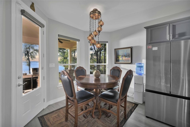 dining area with wood finished floors and baseboards