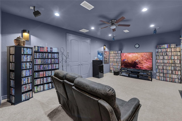 carpeted cinema featuring ceiling fan