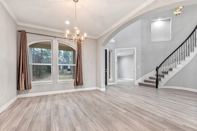 unfurnished dining area featuring light wood finished floors, stairs, and baseboards