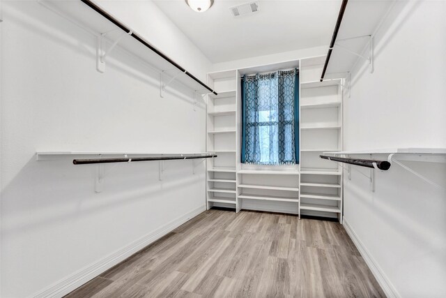 walk in closet with light wood-type flooring