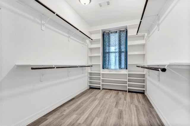 spacious closet featuring wood finished floors and visible vents