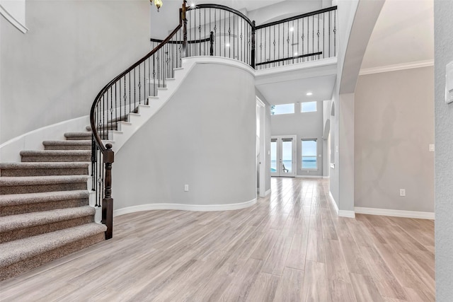 entrance foyer featuring light hardwood / wood-style floors and a high ceiling