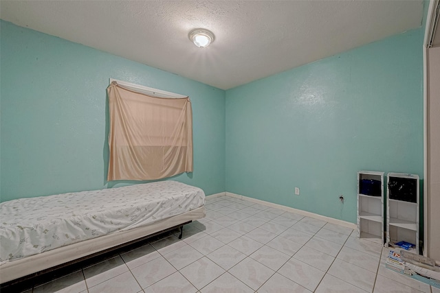 tiled bedroom with a textured ceiling