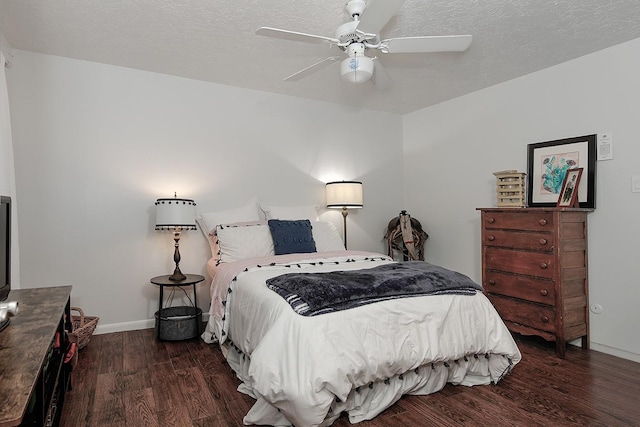 bedroom with dark hardwood / wood-style flooring, ceiling fan, and a textured ceiling