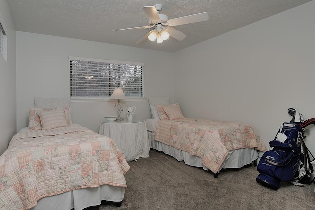 carpeted bedroom with ceiling fan and a textured ceiling