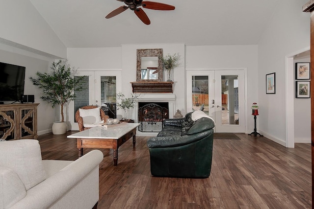 living room with dark hardwood / wood-style flooring, vaulted ceiling, french doors, and a healthy amount of sunlight