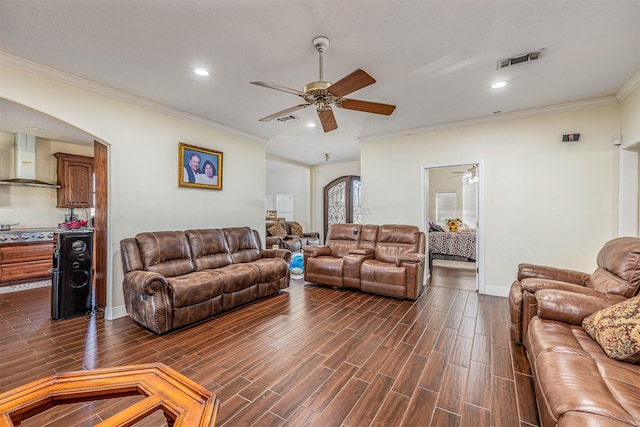 living room with ornamental molding, dark hardwood / wood-style floors, and ceiling fan