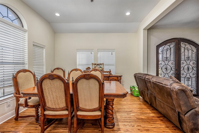 dining room featuring french doors and light hardwood / wood-style flooring