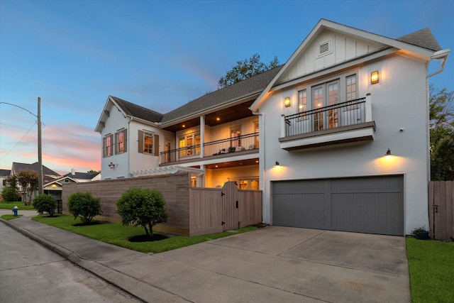 view of front of property featuring a garage and a balcony