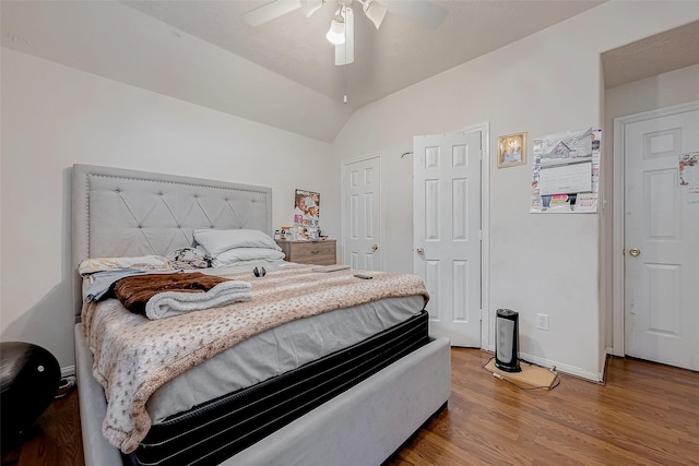 bedroom with hardwood / wood-style flooring, ceiling fan, and lofted ceiling