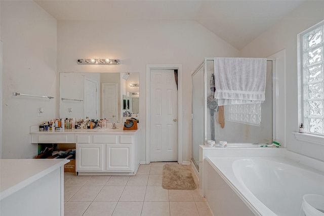 bathroom with lofted ceiling, vanity, tile patterned flooring, and a wealth of natural light