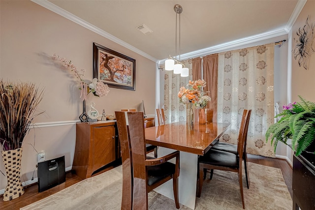 dining room with ornamental molding and wood-type flooring