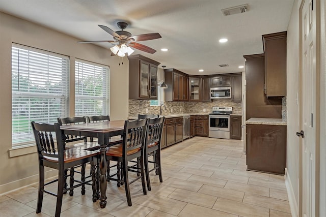 dining room with sink and ceiling fan