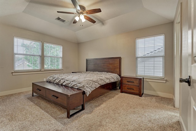 carpeted bedroom with lofted ceiling, ceiling fan, and a tray ceiling