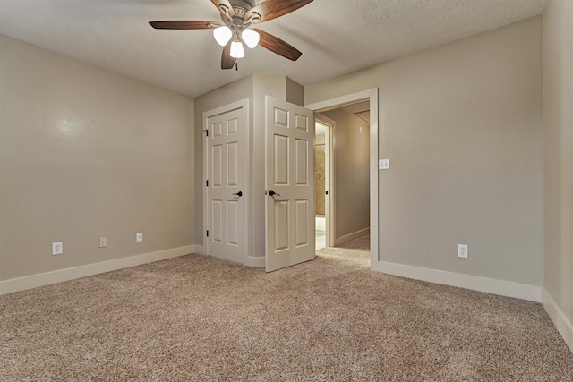 unfurnished bedroom with ceiling fan, a textured ceiling, and carpet