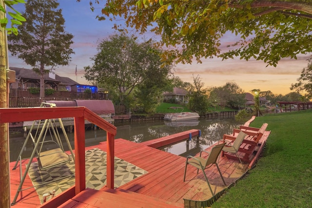 dock area featuring a water view and a yard