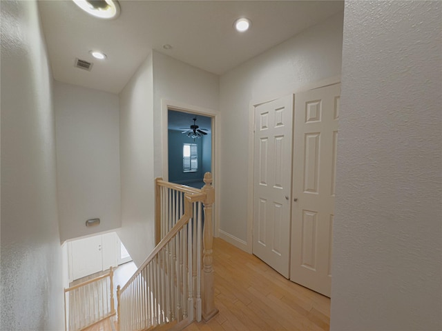 hallway with light hardwood / wood-style floors