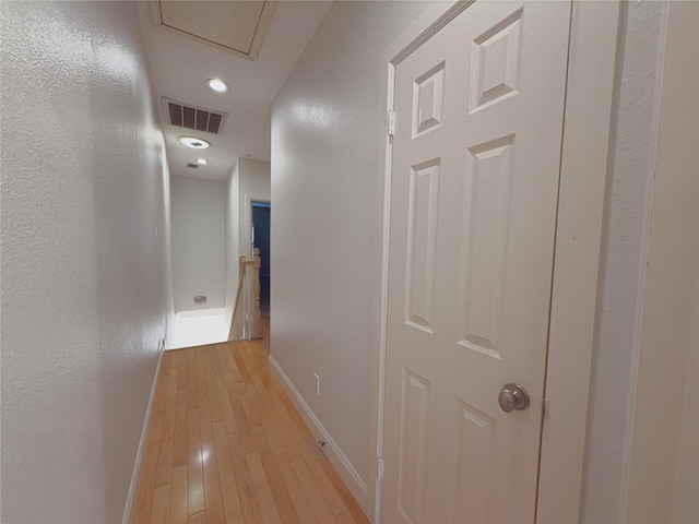 hallway with light hardwood / wood-style flooring