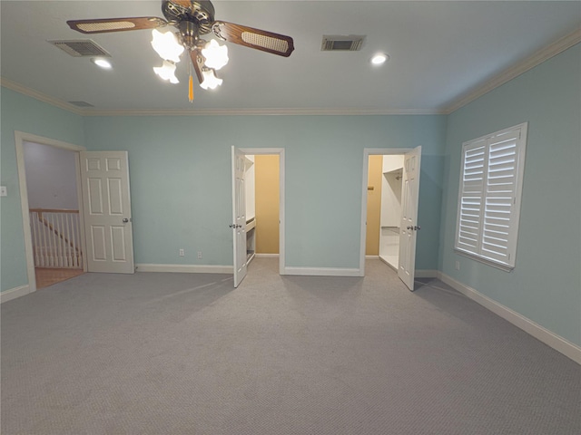 unfurnished bedroom featuring ceiling fan, light colored carpet, ornamental molding, and a spacious closet