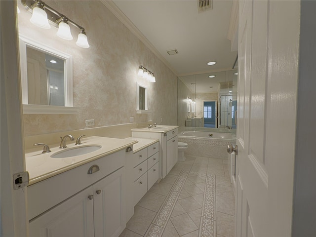 bathroom with tiled tub, vanity, ornamental molding, tile patterned floors, and toilet