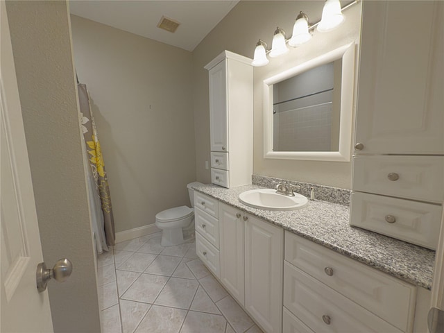 bathroom featuring vanity, walk in shower, tile patterned floors, and toilet