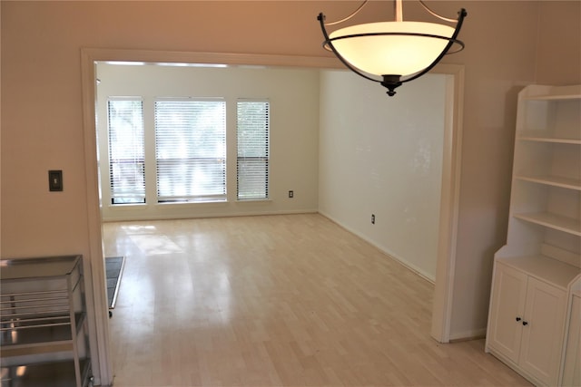 unfurnished dining area featuring light hardwood / wood-style flooring