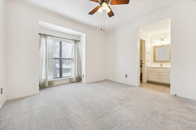 unfurnished bedroom with crown molding, light carpet, connected bathroom, ceiling fan, and baseboards