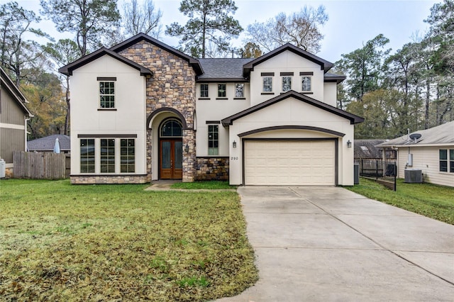 view of front of home featuring cooling unit, a garage, and a front yard