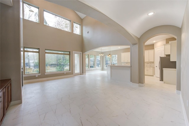 unfurnished living room featuring a healthy amount of sunlight