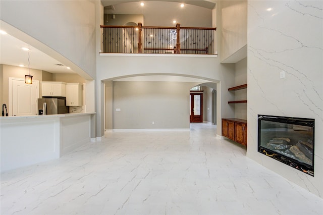 unfurnished living room with sink and a fireplace