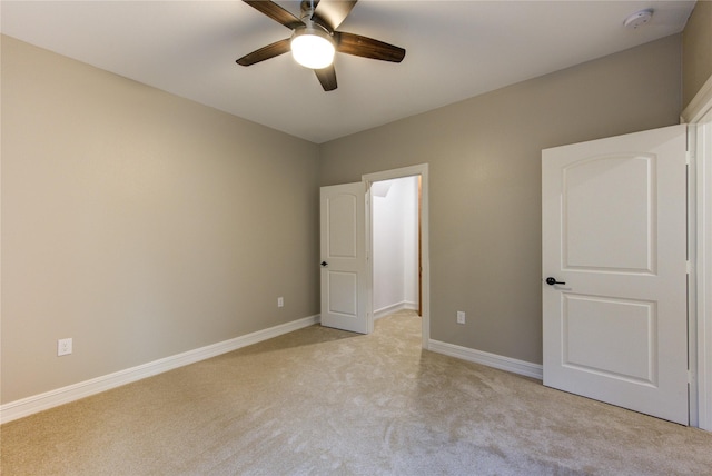 unfurnished bedroom featuring light carpet and ceiling fan