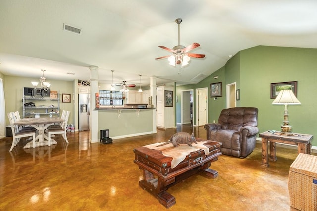 living room with decorative columns, vaulted ceiling, ceiling fan with notable chandelier, and concrete floors