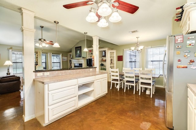 kitchen with ceiling fan, vaulted ceiling, stainless steel refrigerator, and a healthy amount of sunlight